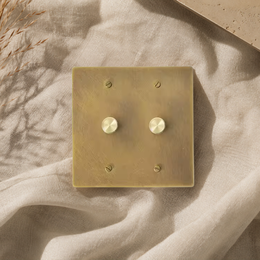 Architectural double dimmer switch crafted from solid brass.