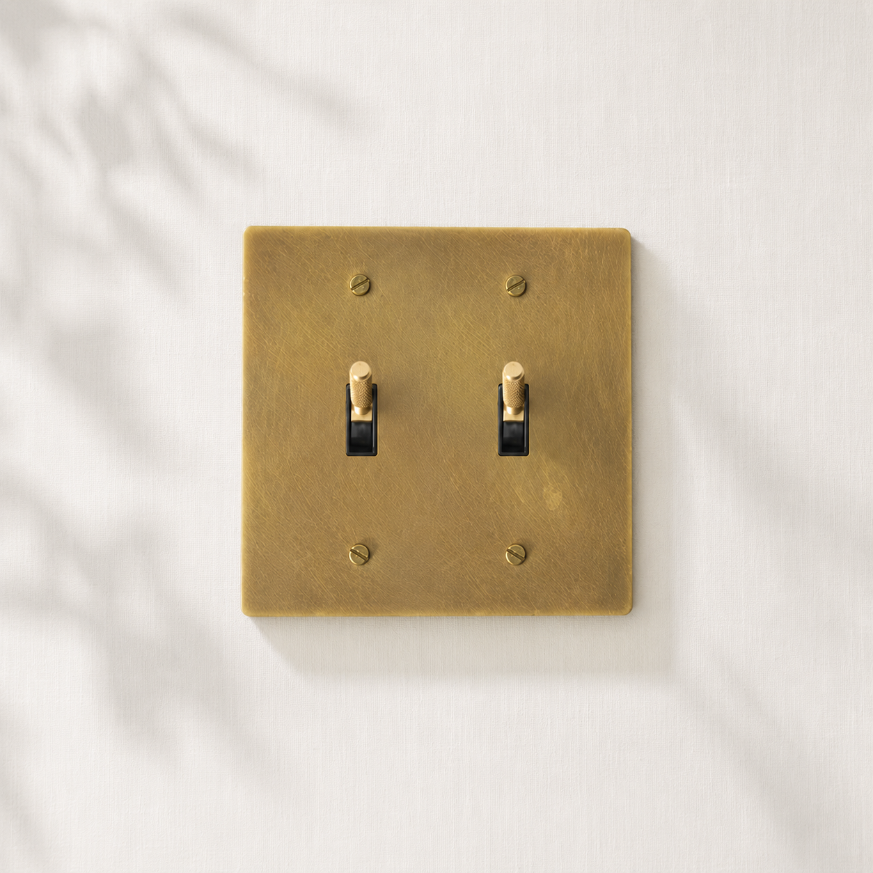 Double solid brass toggle light switch with a brushed finish for modern interiors.