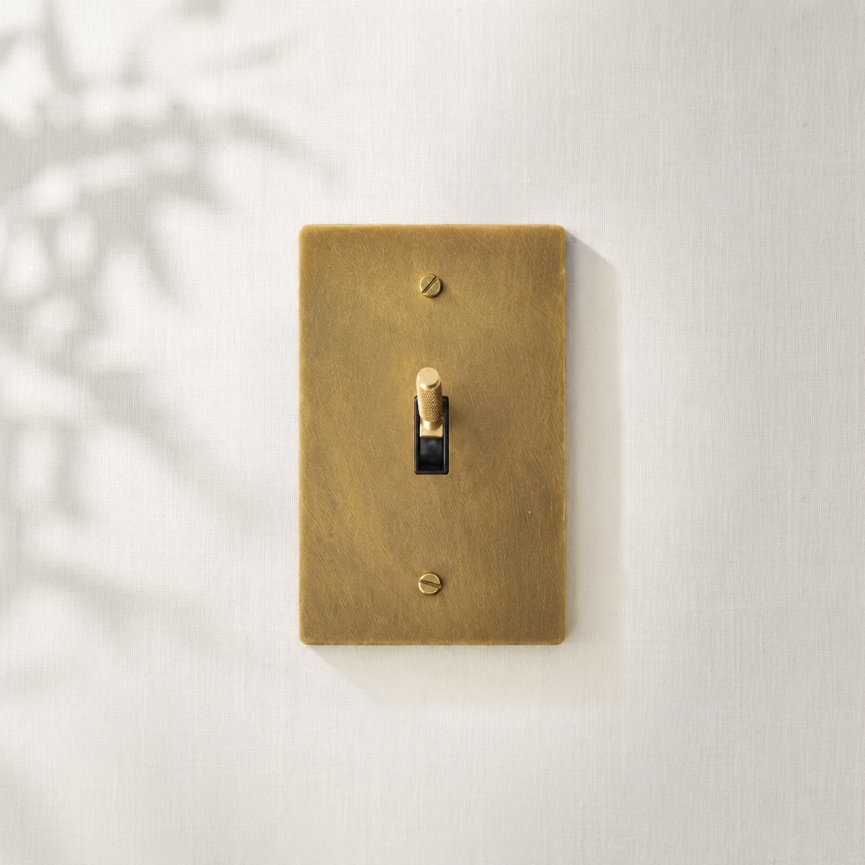 Single solid brass toggle light switch with a brushed finish for timeless interiors.
