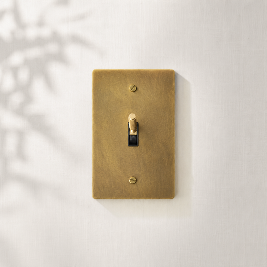 Single solid brass toggle light switch with a brushed finish for timeless interiors.