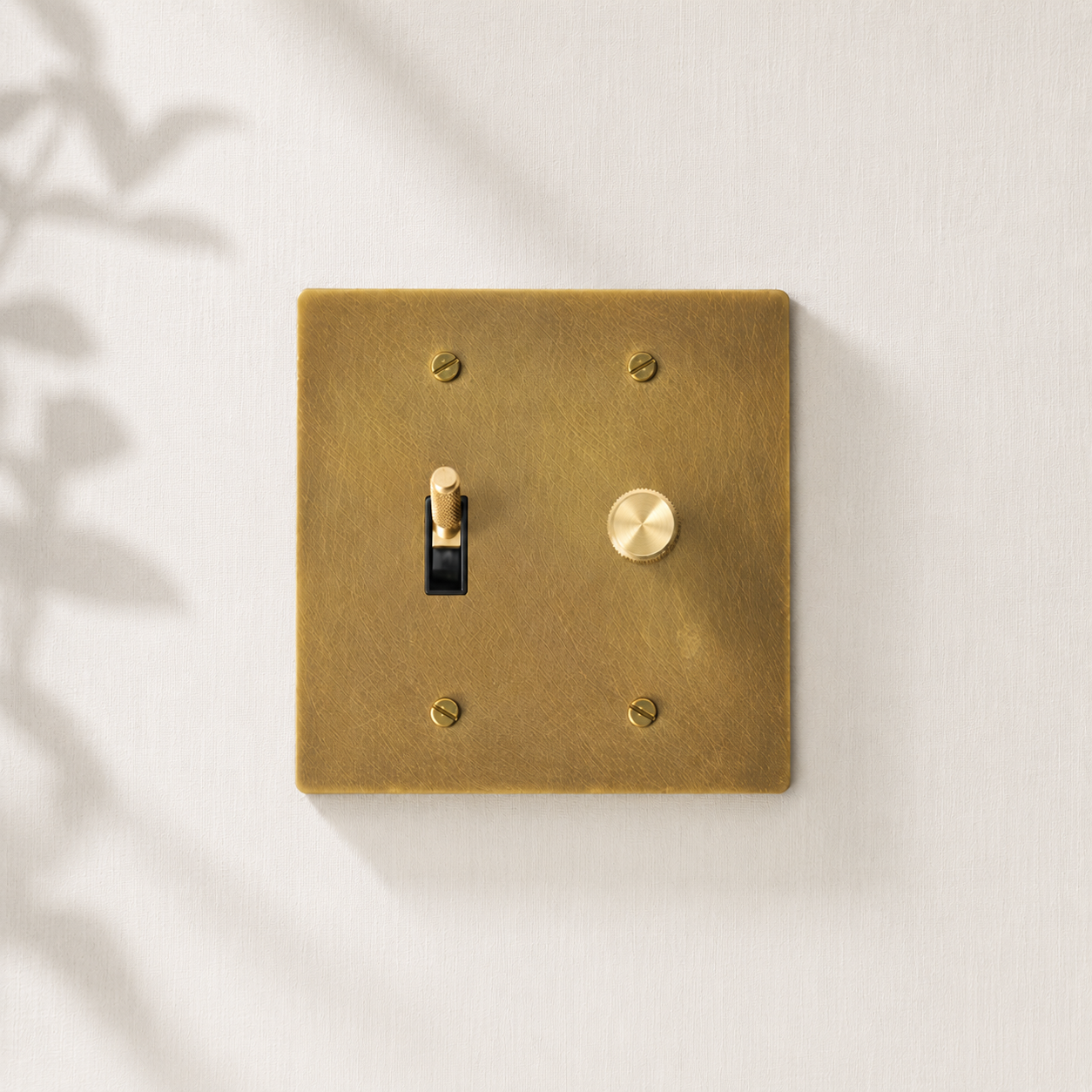 Solid brass toggle and dimmer switch with a brushed finish.